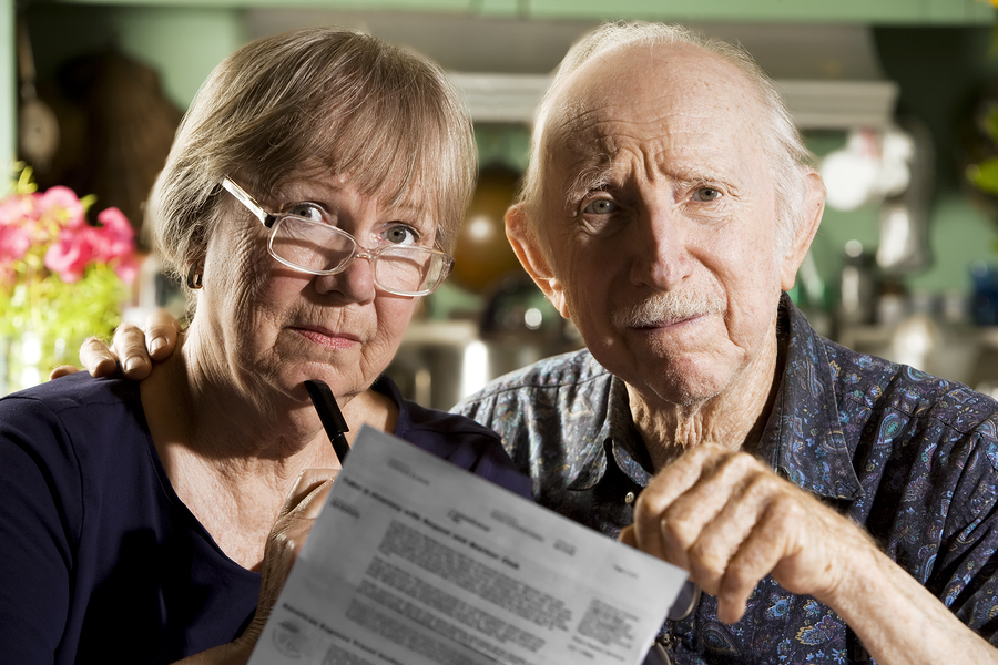 Senior couple reviewing paperwork with reservation